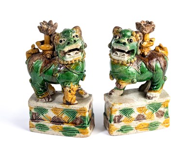 Lot 17 - A PAIR OF CHINESE SANCAI GLAZED BUDDHIST LION JOSS STICK HOLDERS, KANGXI PERIOD (1662-1722)