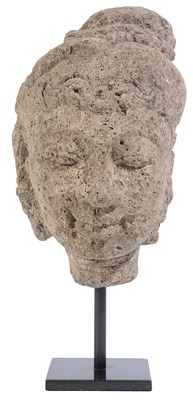 Lot 56 - A MAJAPAHIT CARVED PUMICE HEAD OF A DEITY, JAVA, 13TH / 14TH CENTURY