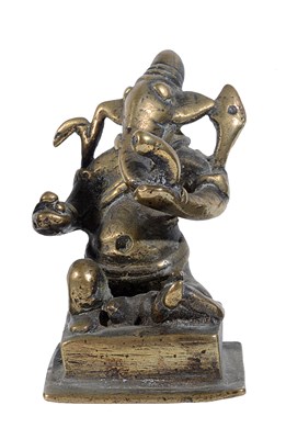 Lot 78 - A BRASS FIGURE OF GANESHA, WESTERN DECCAN, INDIA, CIRCA 18TH CENTURY