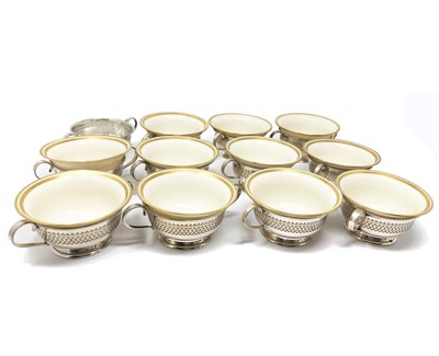 Lot 242 - TWELVE AMERICAN SILVER CONSOMME HOLDERS AND ELEVEN PORCELAIN LINERS