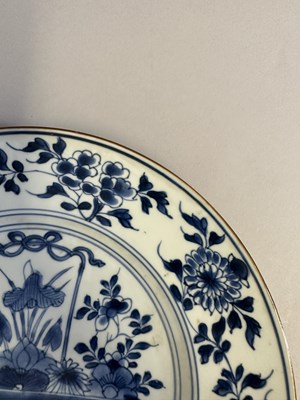 Lot 44 - A PAIR OF CHINESE BLUE AND WHITE 'FLOWER BASKET' PLATES, QING DYNASTY, KANGXI PERIOD (1662-1722)