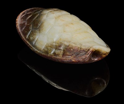 Lot 87 - A CHINESE CELADON AND RUSSET JADE TURTLE SHELL