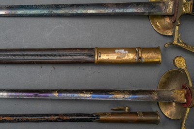 Lot 92 - A FRENCH OFFICER’S EPÉE FOR A GENDARMERIE OFFICER; A FRENCH EPÉE FOR A MILITARY OFFICIAL, LATE 19TH CENTURY AND ANOTHER, IN 19TH CENTURY STYLE
