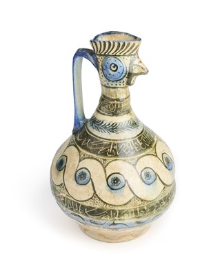 Lot 68 - A KASHAN BLUE, BLACK AND WHITE GLAZED COCKEREL-HEAD POTTERY EWER, PERSIA, 13TH CENTURY