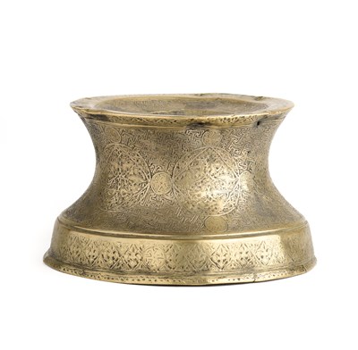 Lot 93 - A BRASS CANDLESTICK BASE, WESTERN IRAN, CIRCA 14TH CENTURY