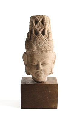 Lot 193 - A BUFF SANDSTONE HEAD OF A DEITY, CENTRAL INDIA, CIRCA 11TH CENTURY