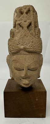 Lot 193 - A BUFF SANDSTONE HEAD OF A DEITY, CENTRAL INDIA, CIRCA 11TH CENTURY