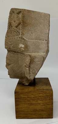 Lot 193 - A BUFF SANDSTONE HEAD OF A DEITY, CENTRAL INDIA, CIRCA 11TH CENTURY