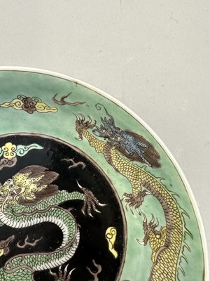 Lot 16 - A CHINESE FAMILLE-NOIR 'DRAGON' DISH, KANGXI PERIOD (1662-1722)