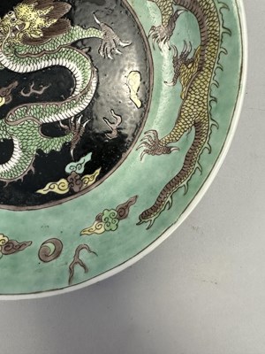 Lot 16 - A CHINESE FAMILLE-NOIR 'DRAGON' DISH, KANGXI PERIOD (1662-1722)