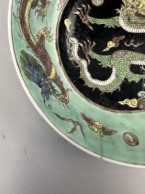 Lot 16 - A CHINESE FAMILLE-NOIR 'DRAGON' DISH, KANGXI PERIOD (1662-1722)