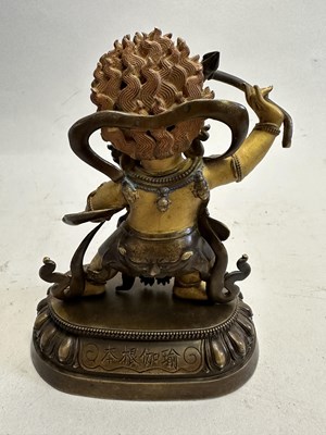 Lot 191 - A SINO-TIBETAN PARCEL GILT BRONZE FIGURE OF MAHAKALA, CHINA, 19TH CENTURY