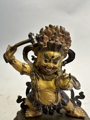 Lot 191 - A SINO-TIBETAN PARCEL GILT BRONZE FIGURE OF MAHAKALA, CHINA, 19TH CENTURY