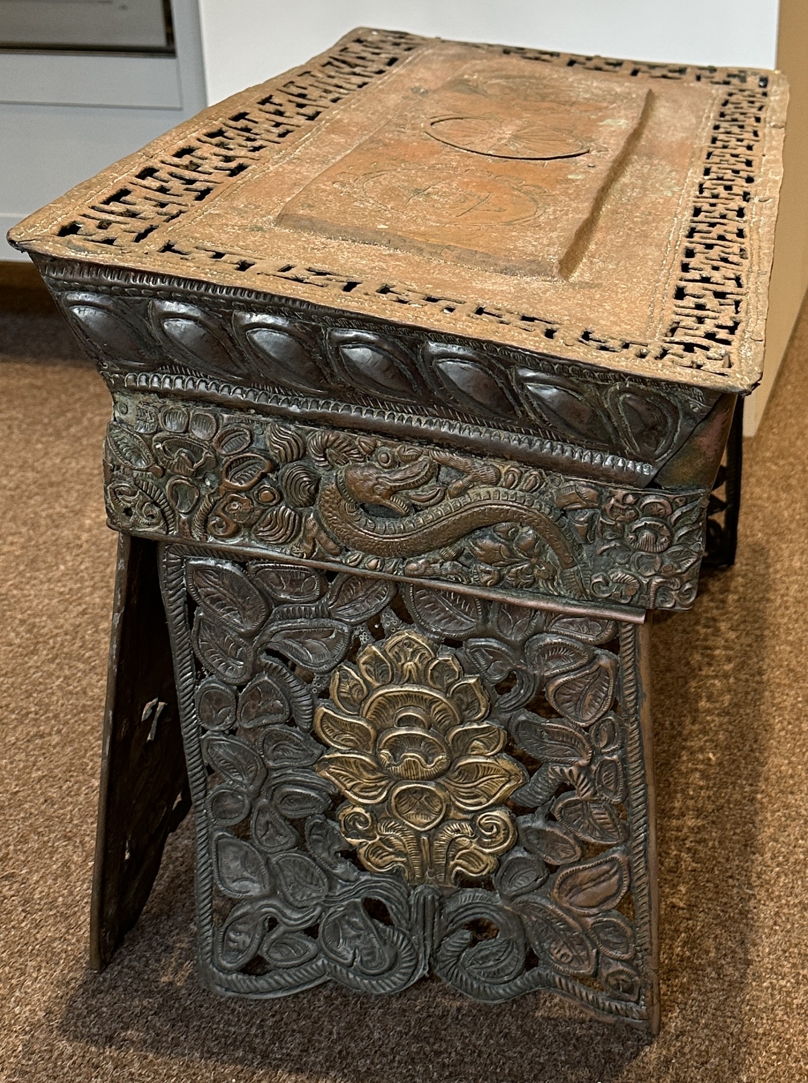 Lot 179 A COPPER REPOUSSE FOLDING ALTAR TABLE, TIBET,