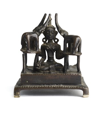 Lot 249 - AN UNUSUAL SMALL BRONZE SHRINE DEPICTING GAJALAKSHMI, INDIA, 19TH CENTURY