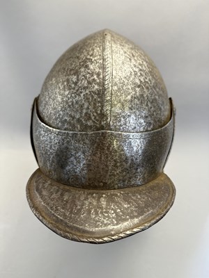 Lot 230 - A NORTH ITALIAN CLOSE HELMET, FIRST QUARTER OF THE 17TH CENTURY