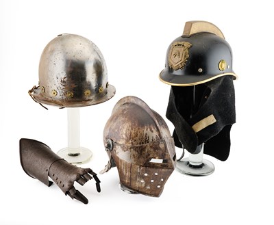 Lot 601 - □ A MORION IN EARLY 17TH CENTURY STYLE, A CLOSE HELMET IN 16TH CENTURY STYLE, A DECORATED GAUNTLET IN LATE 16TH/17TH CENTURY STYLE AND A FIREMAN’S HELMET, 20TH CENTURY