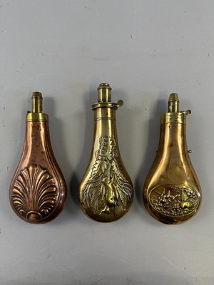 Lot 612 - □ THREE COPPER ALLOY POWDER-FLASKS, 19TH CENTURY AND LATER