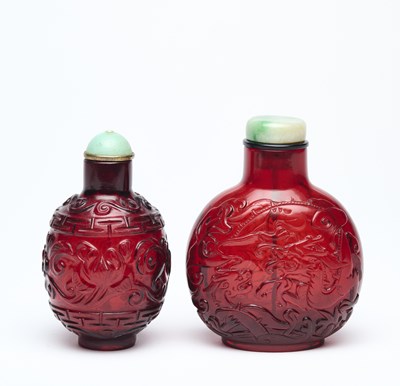 Lot 83 - TWO CHINESE CARVED TRANSPARENT RUBY-RED GLASS SNUFF BOTTLES