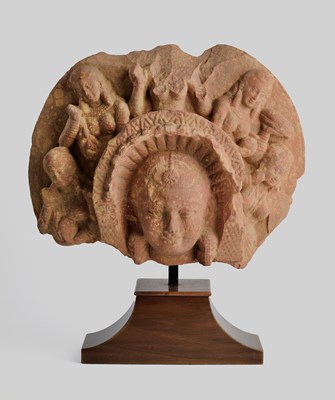 Lot 158 - A MOTTLED PINK SANDSTONE FRAGMENT DEPICTING THE MATRIKA SHASHTHI, MATHURA, INDIA, 2ND/3RD CENTURY