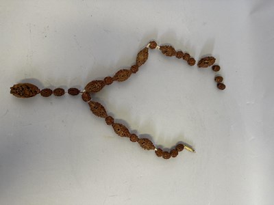 Lot 7 - A CHINESE CARVED HEDIAO NUT SEED NECKLACE, QING DYNASTY, 19TH CENTURY