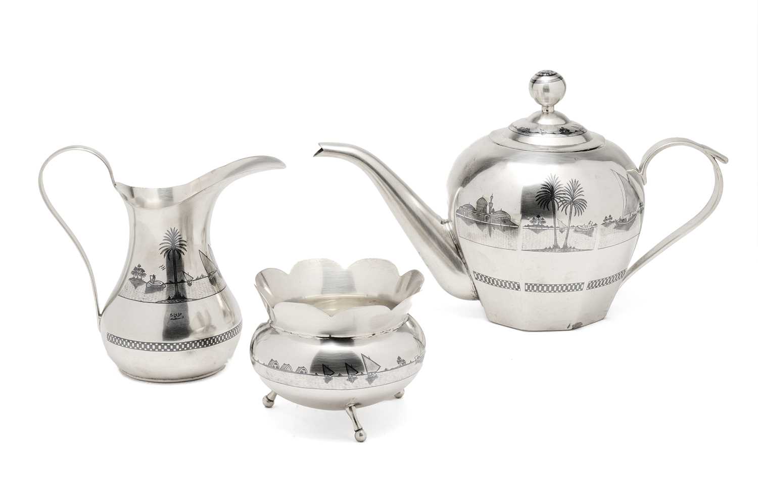 Lot 41 - AN IRAQI SILVER AND NIELLO THREE-PIECE TEA
