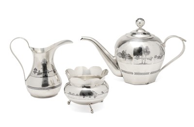 Lot 41 - AN IRAQI SILVER AND NIELLO THREE-PIECE TEA SET, PROBABLY BAGHDAD OR OMARA, CIRCA 1930