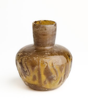 Lot 69 - AN AMBER MOULD-BLOWN GLASS BOTTLE, PERSIA OR CENTRAL ASIA, 11TH/12TH CENTURY