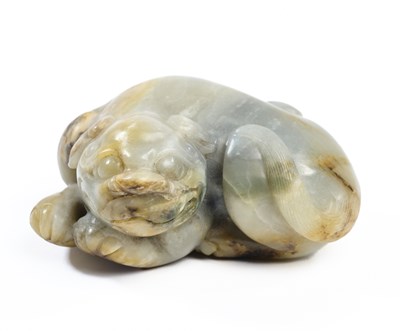 Lot 76 - A CHINESE CELADON JADE LION