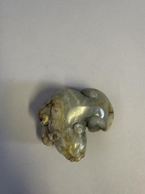 Lot 76 - A CHINESE CELADON JADE LION