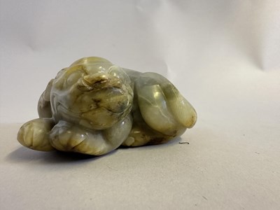 Lot 76 - A CHINESE CELADON JADE LION