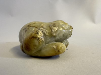 Lot 76 - A CHINESE CELADON JADE LION