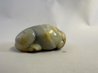Lot 76 - A CHINESE CELADON JADE LION