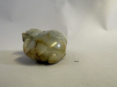 Lot 76 - A CHINESE CELADON JADE LION