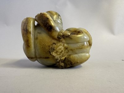 Lot 76 - A CHINESE CELADON JADE LION