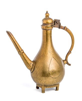 Lot 203 - A MUGHAL BRASS EWER^ NORTHERN INDIA^ CIRCA...