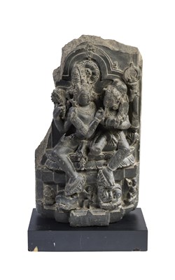 Lot 152 - A GREY STONE FRAGMENTARY STELE DEPICTING UMAMAHESVARA, PALA, EASTERN INDIA, CIRCA 11TH CENTURY