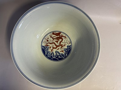Lot 46 - A LARGE CHINESE MING-STYLE BLUE AND WHITE AND IRON-RED 'NINE DRAGON' BOWL