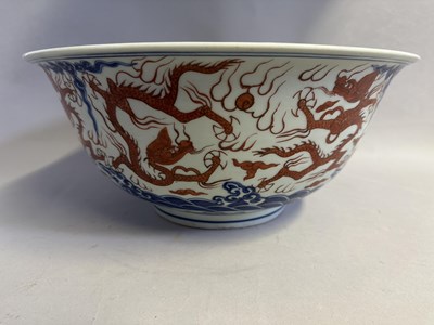 Lot 46 - A LARGE CHINESE MING-STYLE BLUE AND WHITE AND IRON-RED 'NINE DRAGON' BOWL