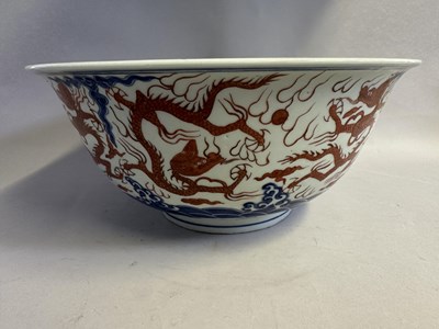 Lot 46 - A LARGE CHINESE MING-STYLE BLUE AND WHITE AND IRON-RED 'NINE DRAGON' BOWL