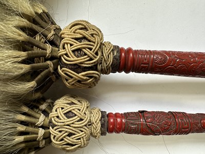 Lot 39 - TWO CHINESE CINNABAR LACQUER FLY WHISKS, QING DYNASTY, 19TH CENTURY