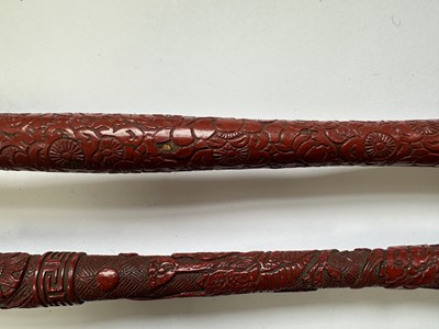 Lot 39 - TWO CHINESE CINNABAR LACQUER FLY WHISKS, QING DYNASTY, 19TH CENTURY