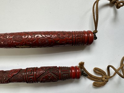 Lot 39 - TWO CHINESE CINNABAR LACQUER FLY WHISKS, QING DYNASTY, 19TH CENTURY