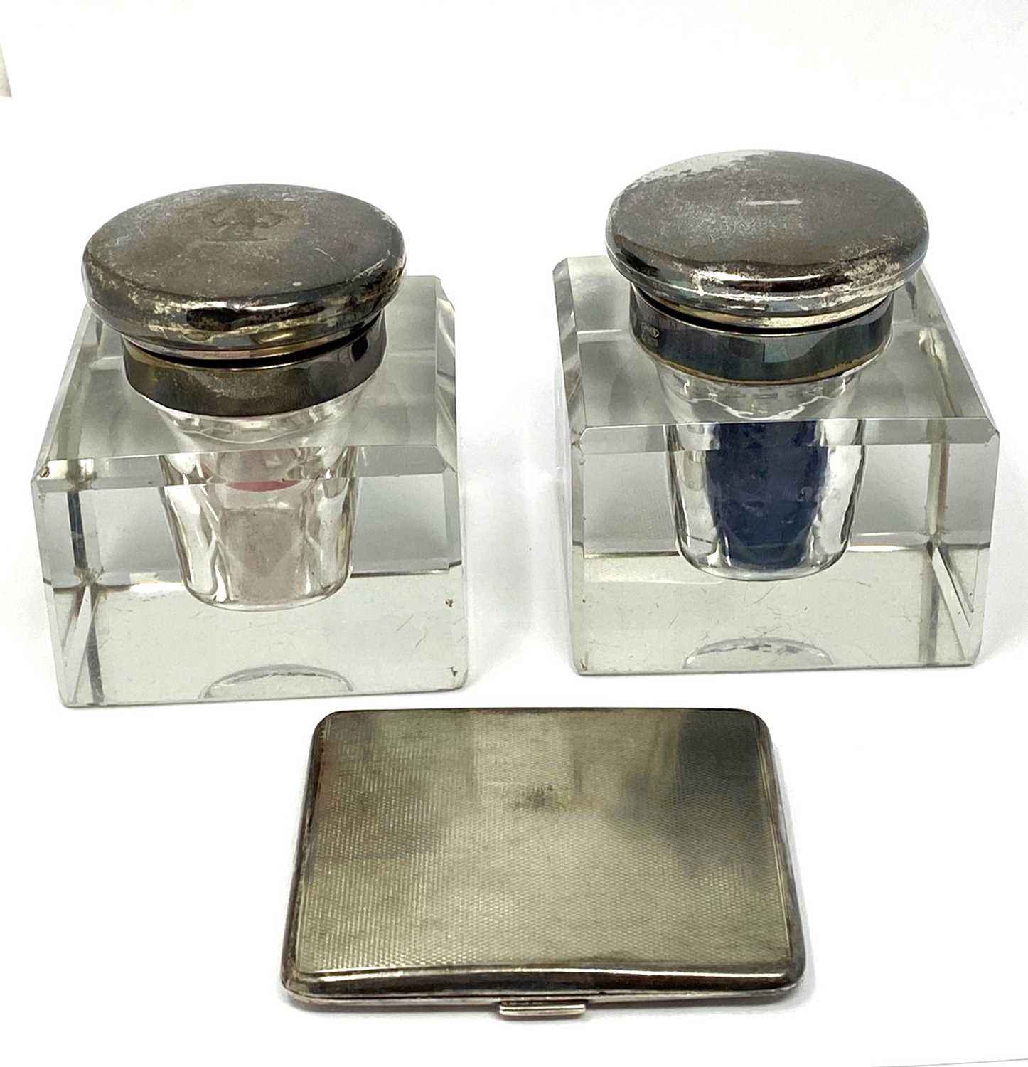 Lot 557 - A PAIR OF GEORGE V SILVER-MOUNTED GLASS INKWELLS, ASPREY & CO. LTD., LONDON, 1928 / 29