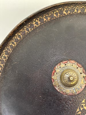 Lot 20 - AN INDIAN HIDE SHIELD (DHAL), 19TH CENTURY, SIGNED BHAGUAN KHOOSALOA, AHMEDABAD