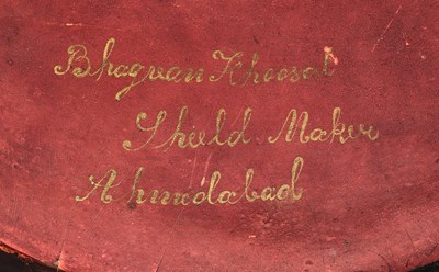 Lot 20 - AN INDIAN HIDE SHIELD (DHAL), 19TH CENTURY, SIGNED BHAGUAN KHOOSALOA, AHMEDABAD