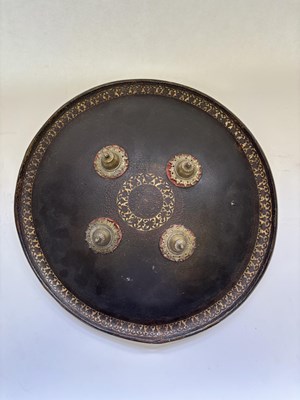 Lot 20 - AN INDIAN HIDE SHIELD (DHAL), 19TH CENTURY, SIGNED BHAGUAN KHOOSALOA, AHMEDABAD