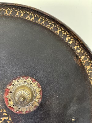 Lot 20 - AN INDIAN HIDE SHIELD (DHAL), 19TH CENTURY, SIGNED BHAGUAN KHOOSALOA, AHMEDABAD