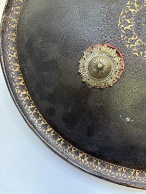 Lot 20 - AN INDIAN HIDE SHIELD (DHAL), 19TH CENTURY, SIGNED BHAGUAN KHOOSALOA, AHMEDABAD