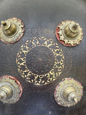 Lot 20 - AN INDIAN HIDE SHIELD (DHAL), 19TH CENTURY, SIGNED BHAGUAN KHOOSALOA, AHMEDABAD